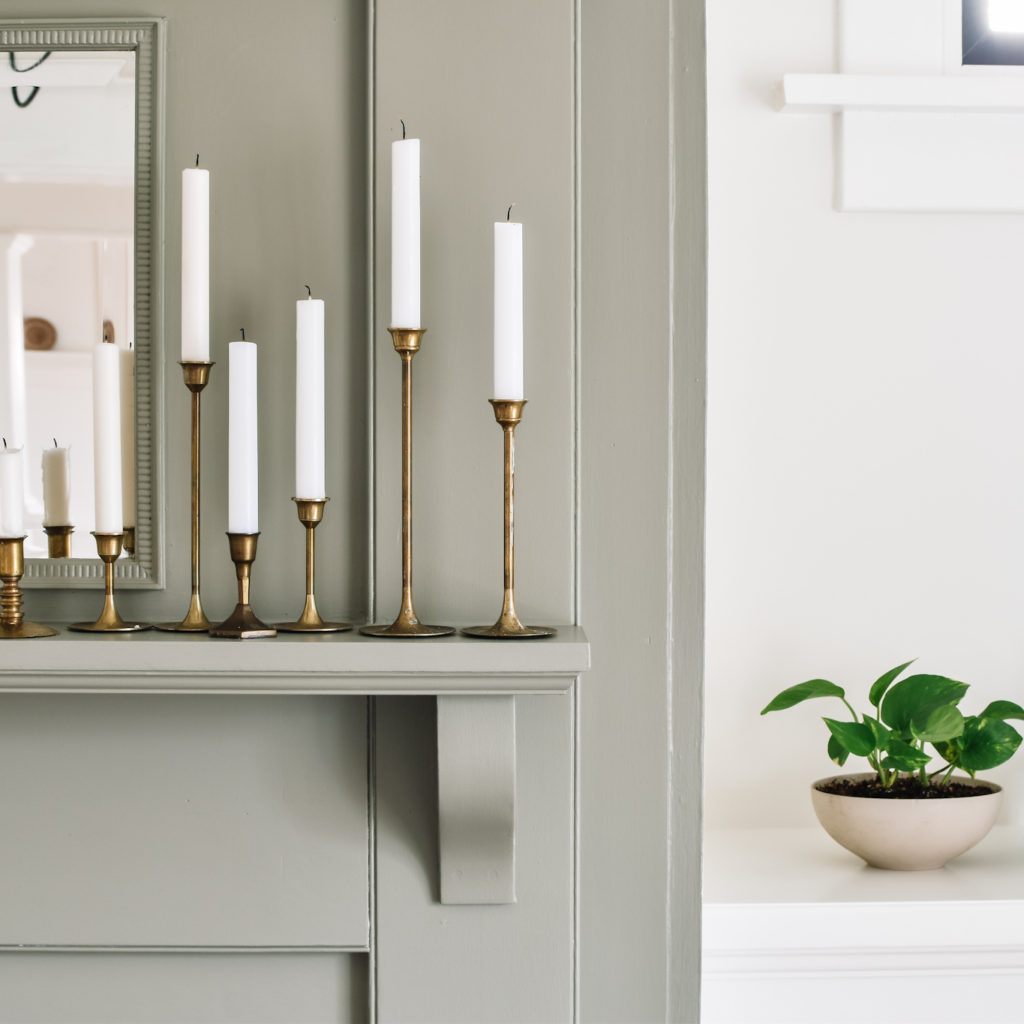 Brass candlesticks, painted fireplace