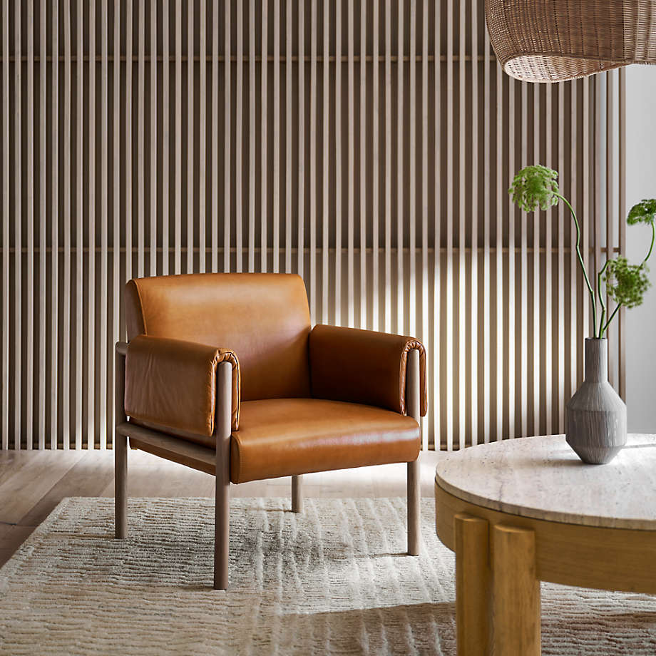 wood slat wall, rattan light fixture, tan leather chair, leather armchair, marble coffee table, round coffee table, light wood coffee table, design trends 2021, natural area rug