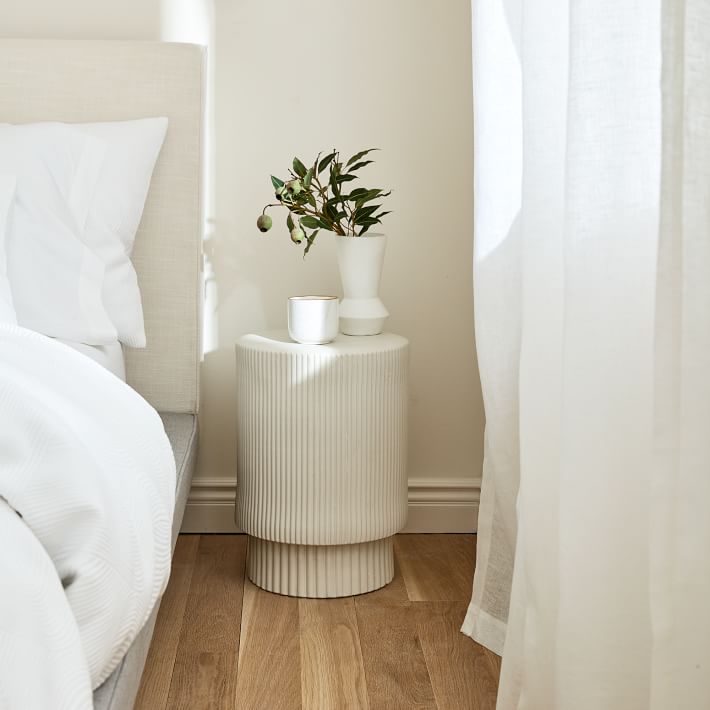 minimal bedroom design, fluted side table, white linen curtains, linen drapes, upholstered headboard, wood flooring, neutral master bedroom 